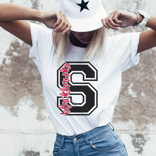 Woman wearing a Sheridan Blackhawks varsity S graphic shirt featuring bold athletic letter design and school spirit artwork