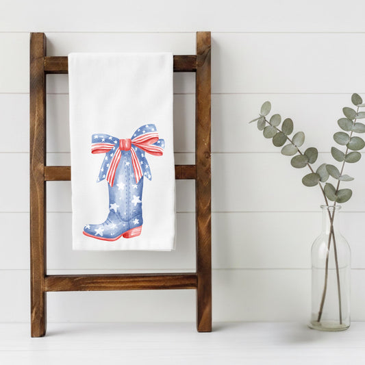 Towel with a patriotic boot design on a wooden ladder against a white background