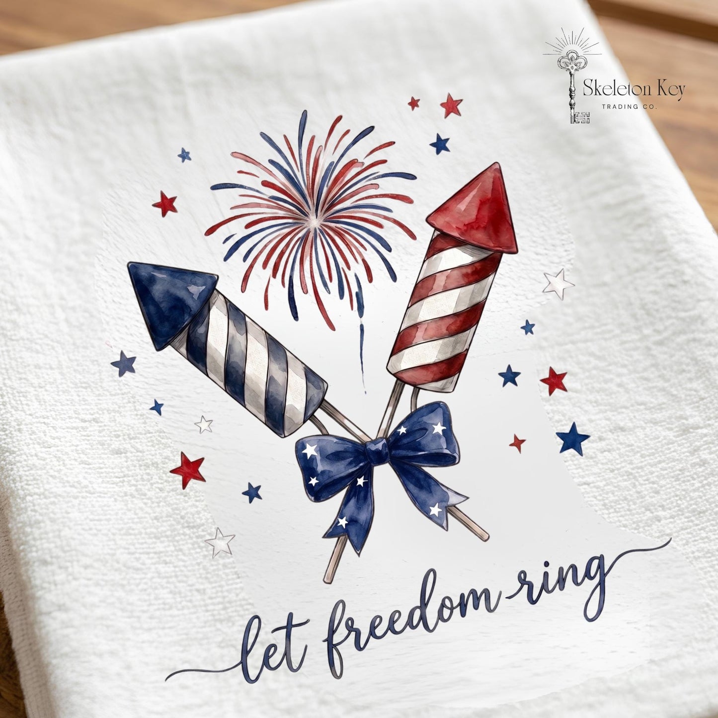 Towel with patriotic firework design and 'let freedom ring' text on a white background.