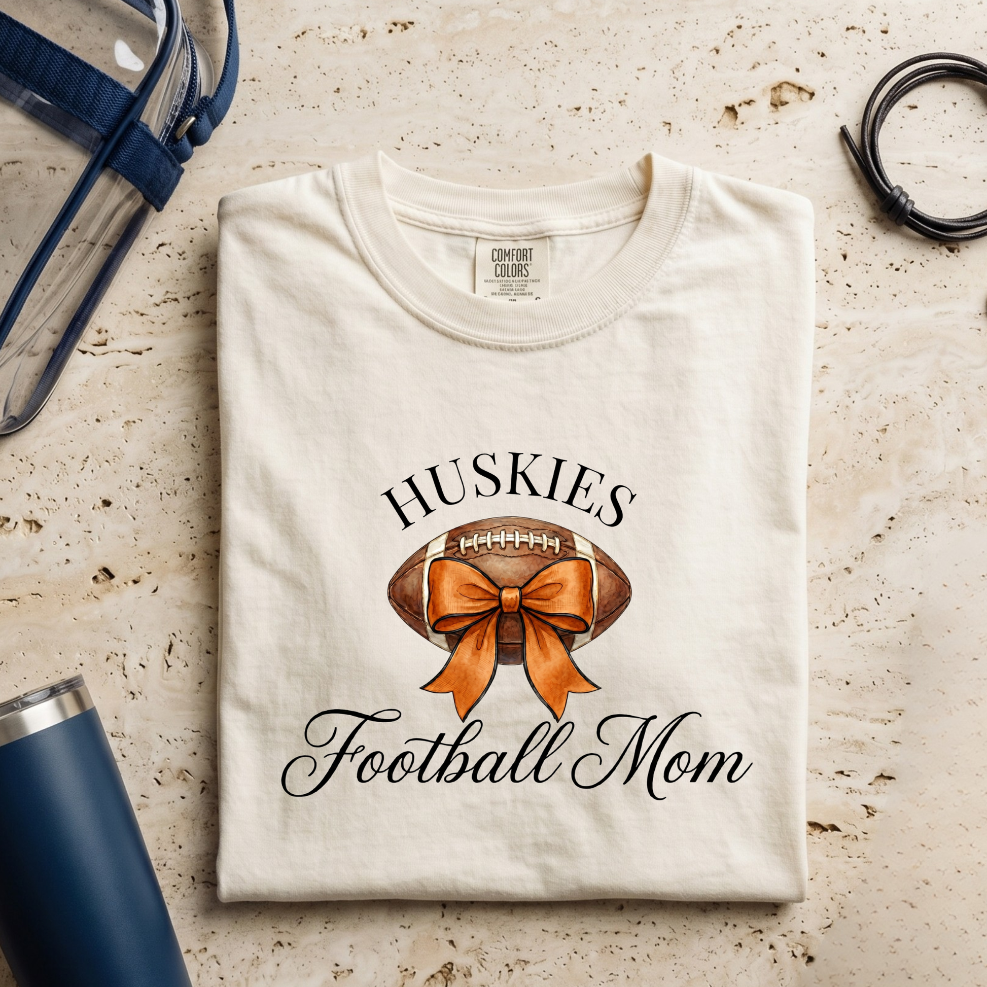 Hamilton Heights Huskies Football Mom Comfort Colors tee with football bow design for football season and game day wear
