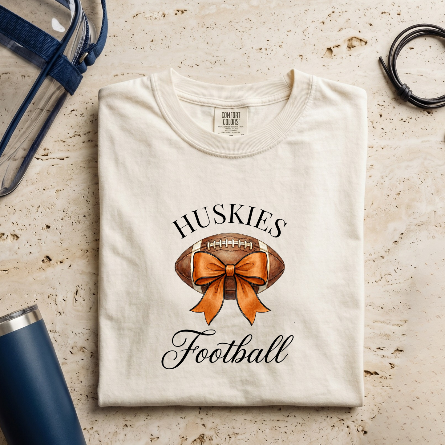 Hamilton Heights Huskies Football Coquette Bow Tee printed on Comfort Colors shirt for football moms and game day fans