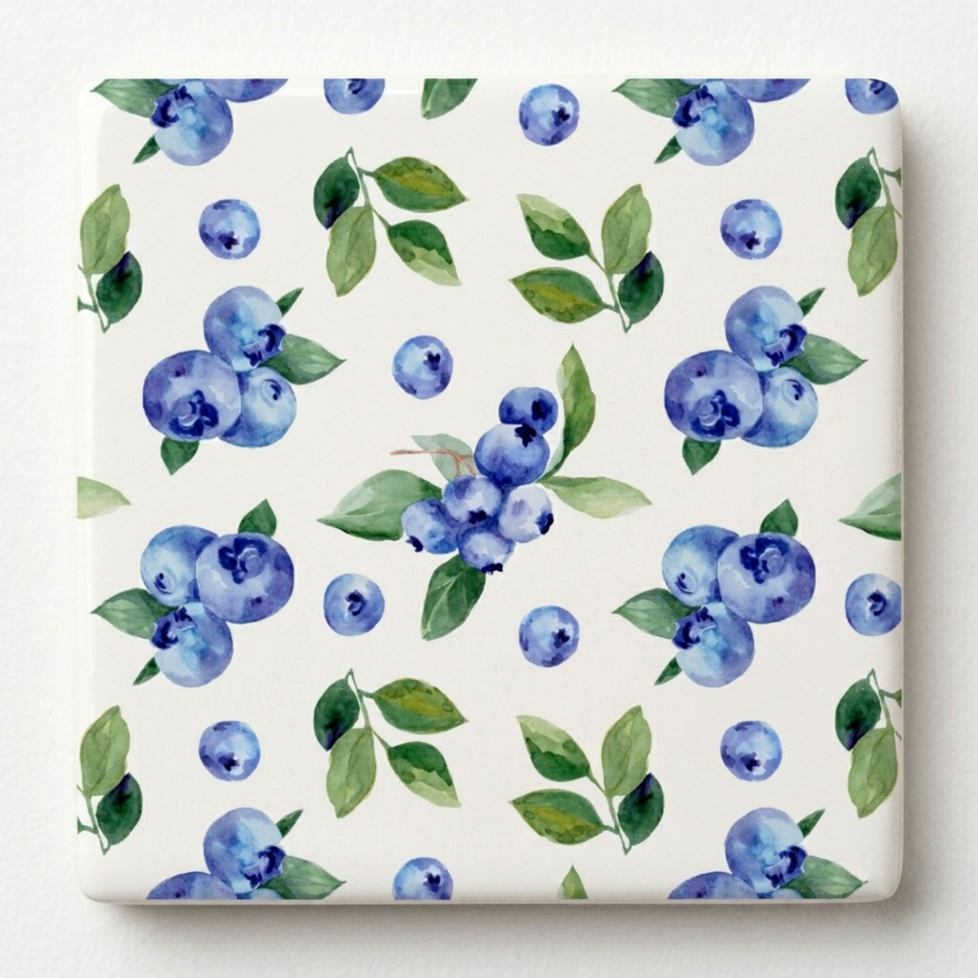Pattern of blueberries and green leaves on a white background