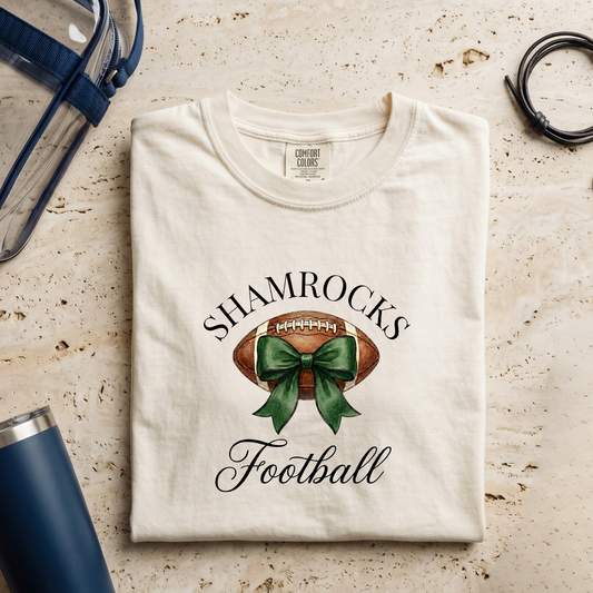 Folded t-shirt with shamrock and football design on a textured surface