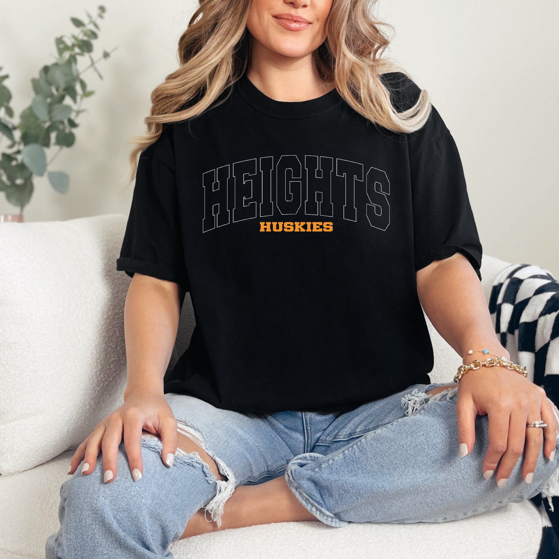 Woman wearing Hamilton Heights Huskies collegiate spirit wear shirt featuring arched HEIGHTS typography and varsity design
