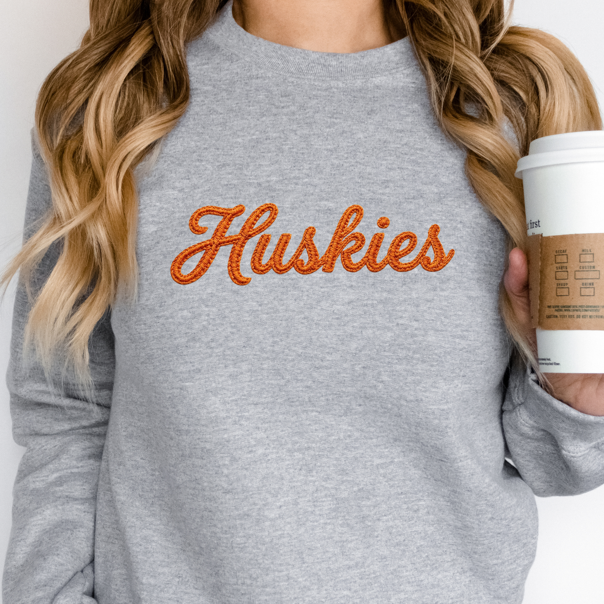 Hamilton Heights Huskies faux embroidery crewneck sweatshirt featuring orange stitched-look script lettering on heather gray sweatshirt