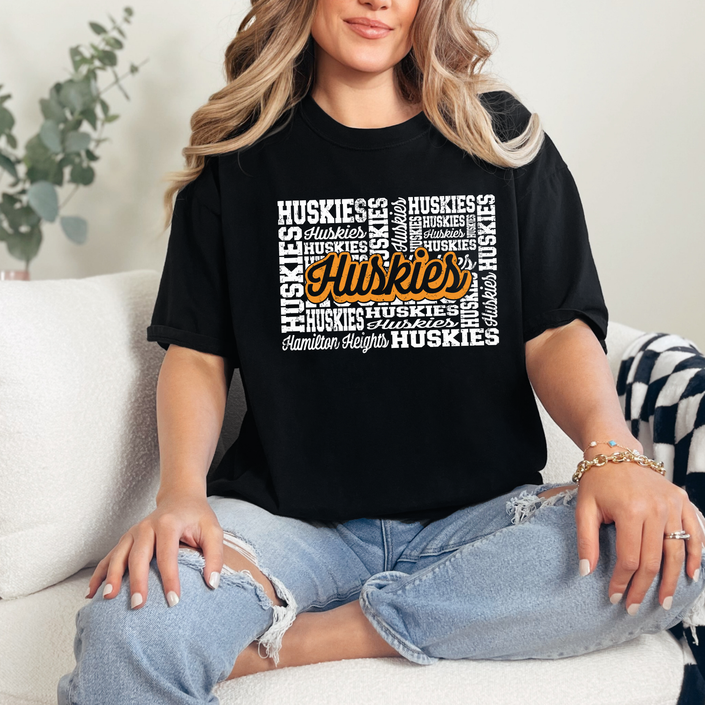 Woman wearing Hamilton Heights Huskies hometown spirit wear shirt with vintage-inspired layered Huskies typography design