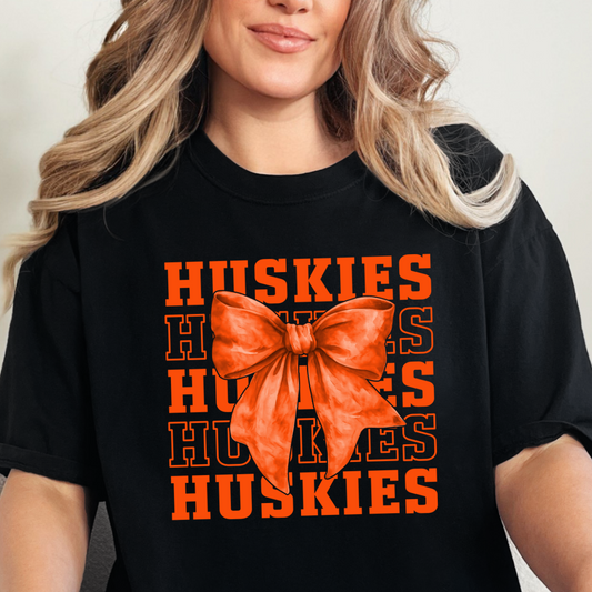 Hamilton Heights Huskies stacked varsity typography design with oversized orange coquette bow for trendy school spirit apparel