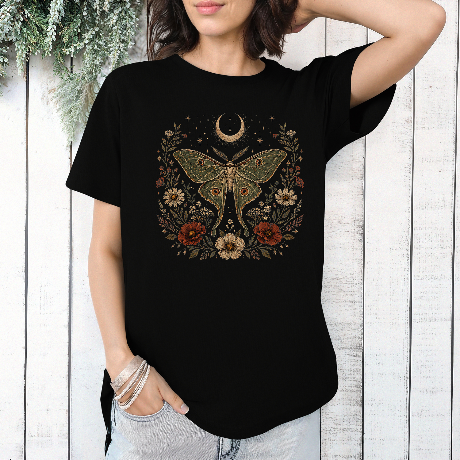 Woman wearing black celestial luna moth graphic tee featuring floral botanical artwork and crescent moon design