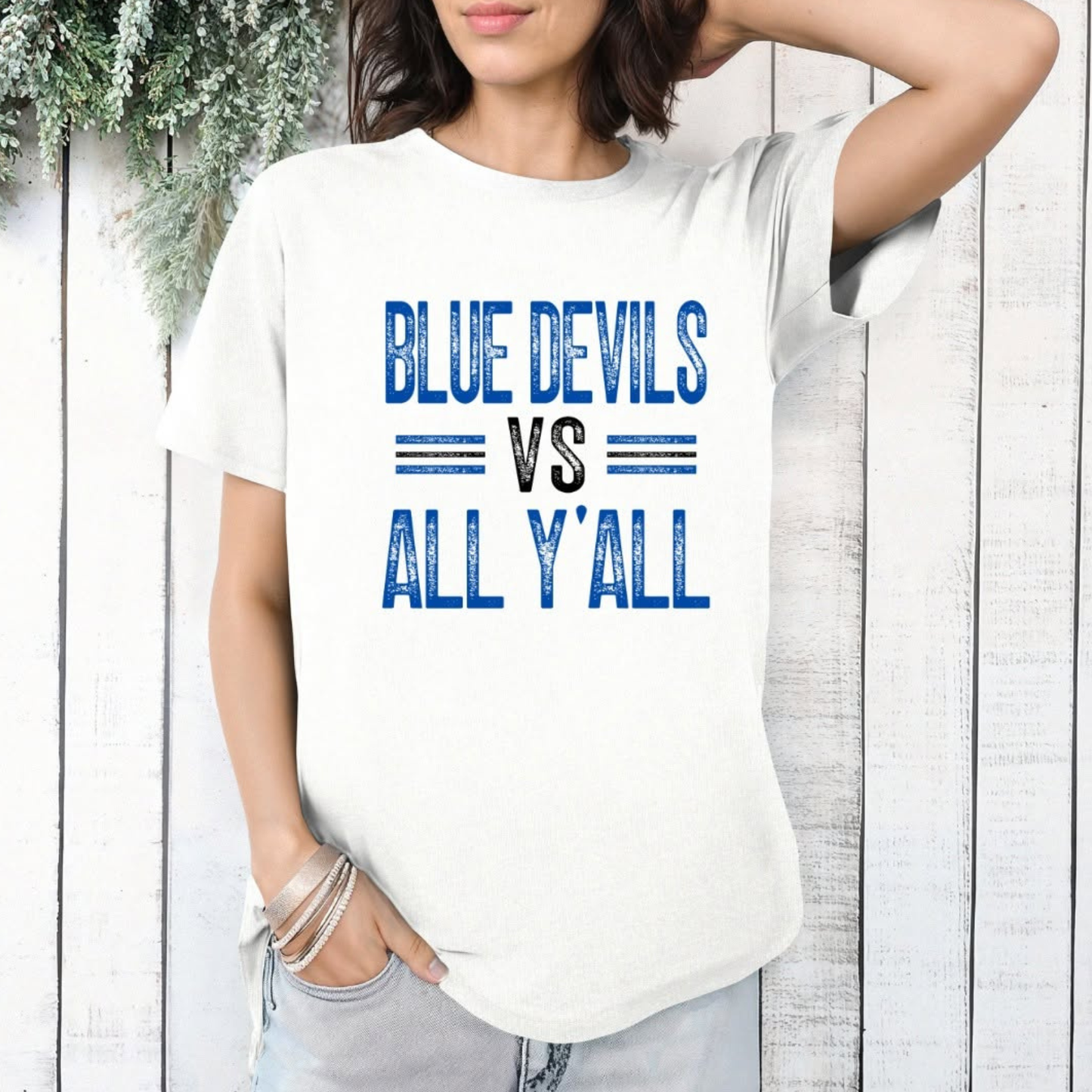 Person wearing a white t-shirt with 'Blue Devils vs All Y'all' text.