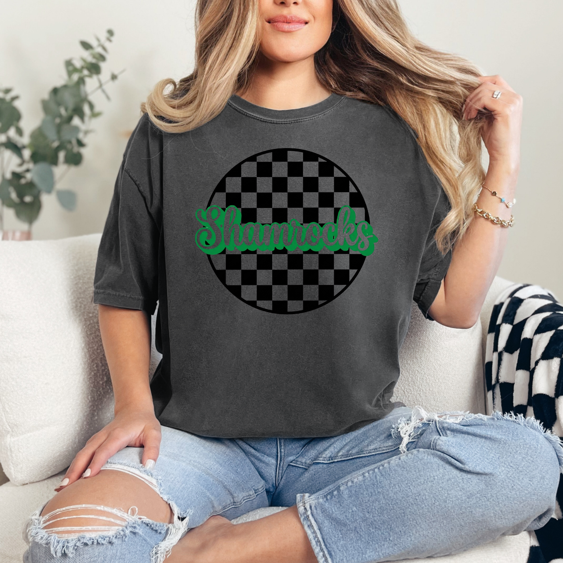Woman wearing a Westfield Shamrocks checkered graphic tee in pepper Comfort Colors shirt mockup