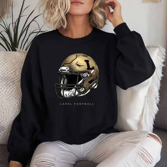 A person wearing a black crewneck sweatshirt featuring a detailed gold football helmet graphic with 'LAPEL FOOTBALL' text.