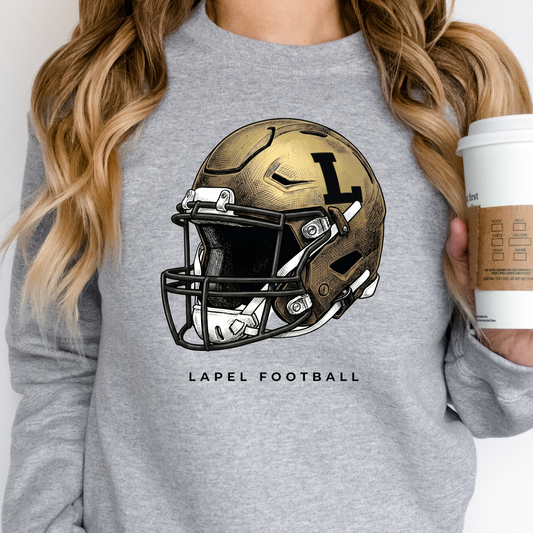 A person wearing a grey crewneck sweatshirt featuring a detailed gold football helmet graphic with 'LAPEL FOOTBALL' text.