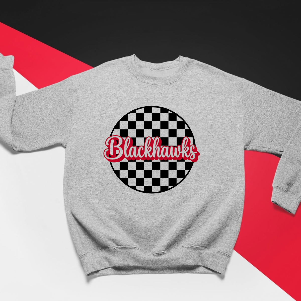 Close-up of Sheridan Blackhawks checkered sweatshirt with red script school spirit graphic and checkerboard pattern