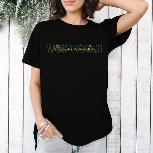 A person wearing a black t-shirt featuring 'WESTFIELD' in green block letters with the word 'Shamrocks' layered in a gold script font.