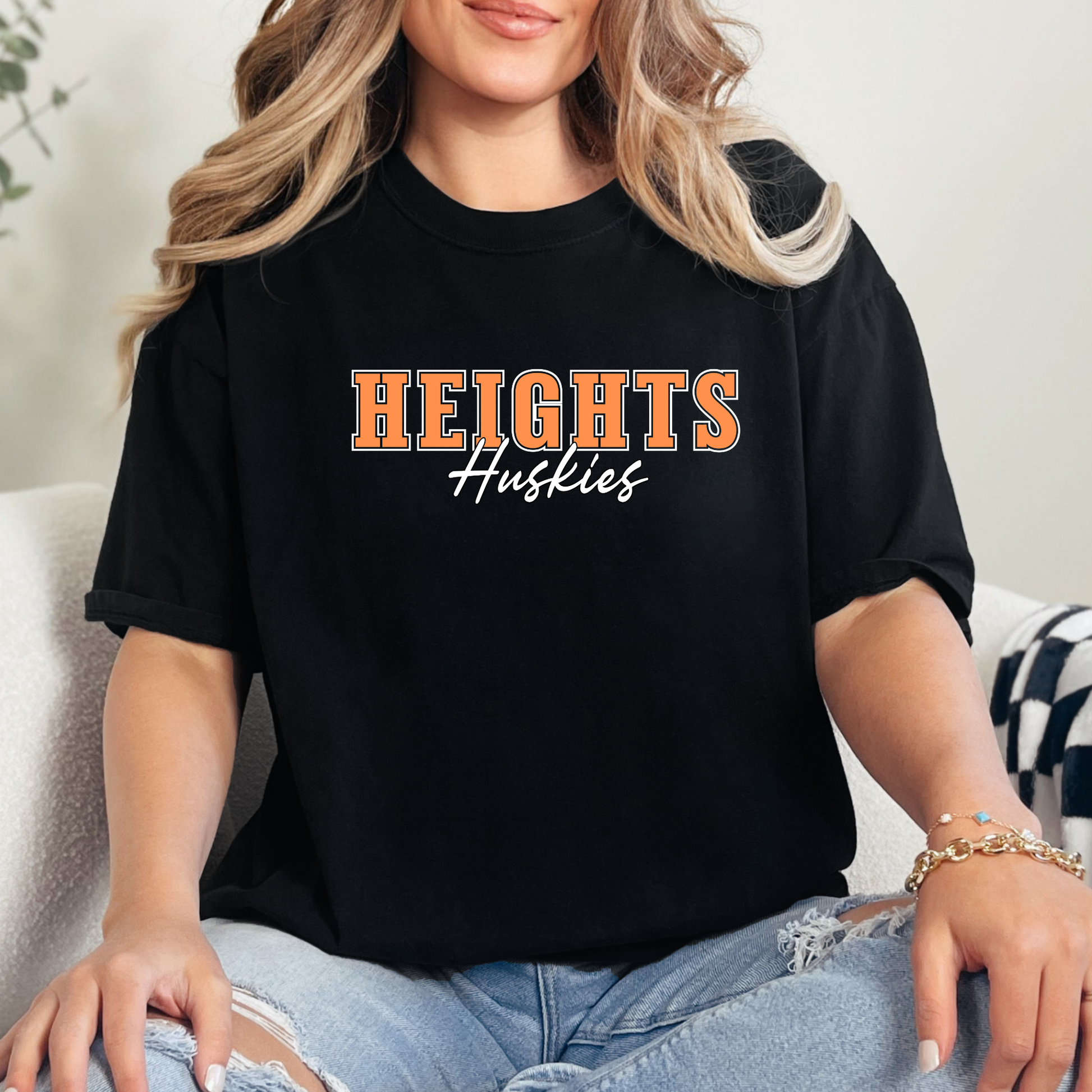 Woman wearing a black t-shirt with 'Heights Huskies' text