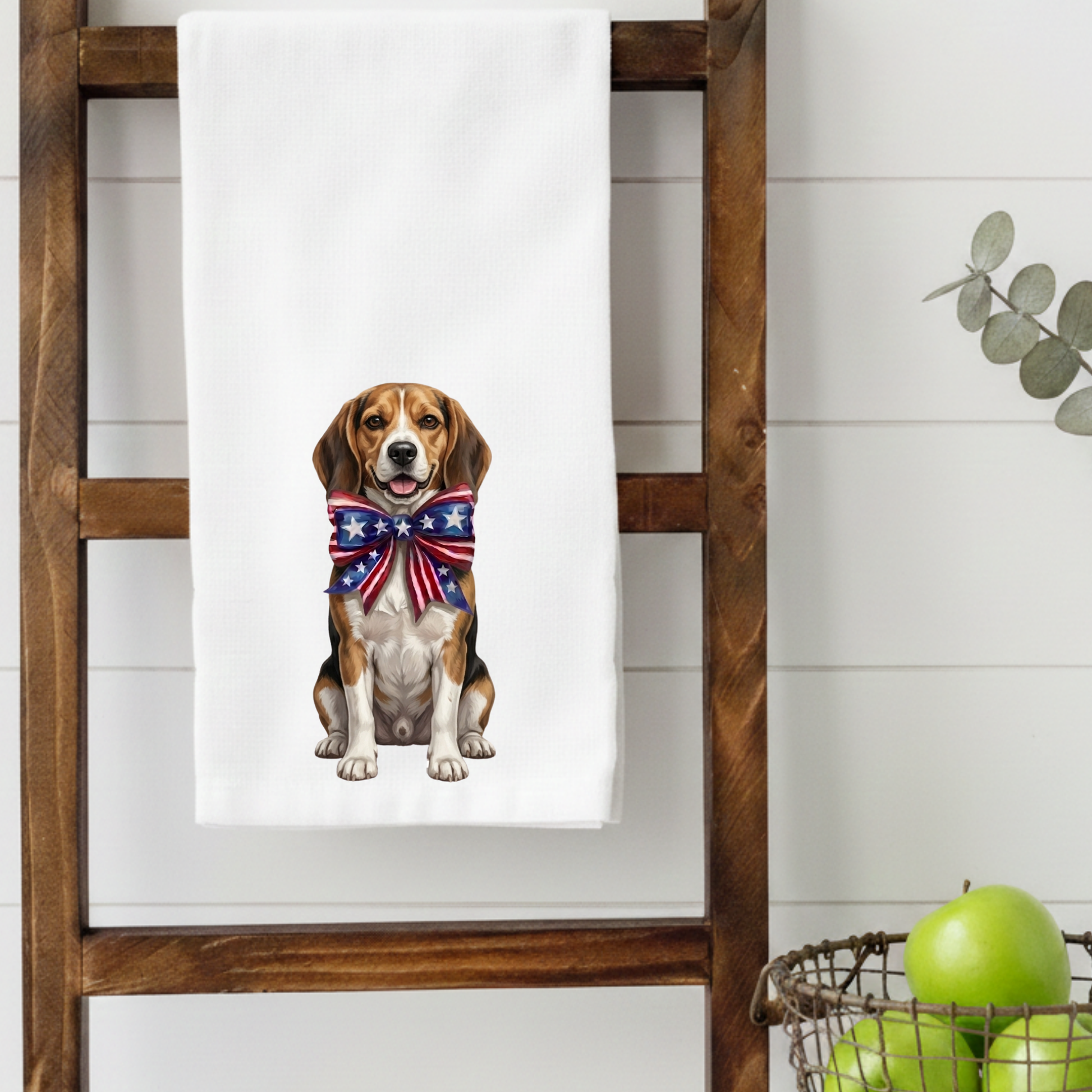 Towel with a Beagle dog wearing a patriotic bow tie hanging on a wooden ladder against a white wall.