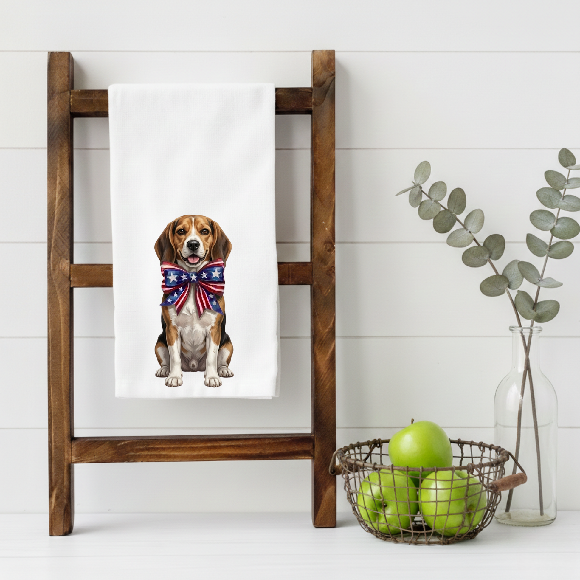 Towel with a Beagle dog wearing a patriotic bandana on a wooden ladder against a white wall.