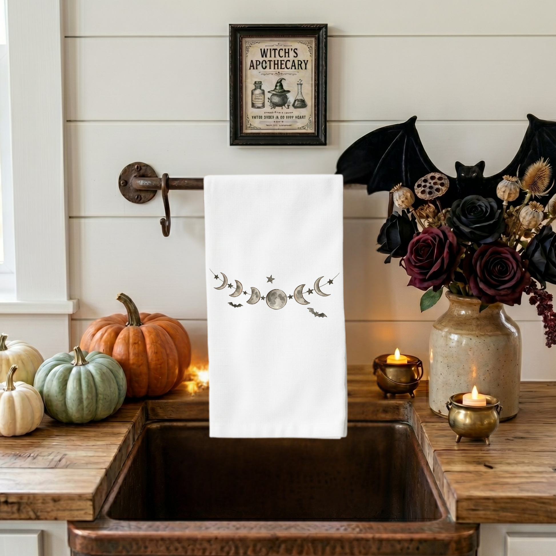 Celestial moon phases Halloween kitchen towel displayed in farmhouse kitchen with copper sink and seasonal decor