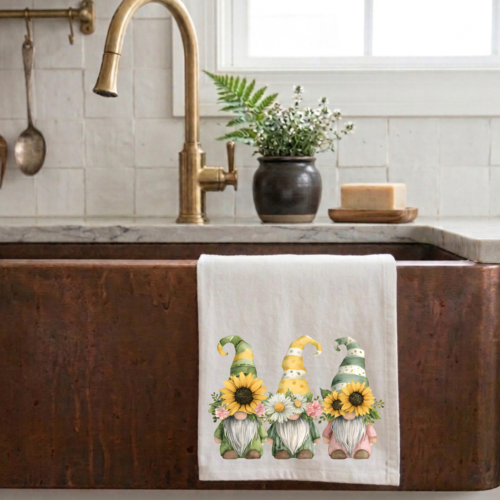 Cottagecore sunflower gnome tea towel hanging on a rustic copper farmhouse sink