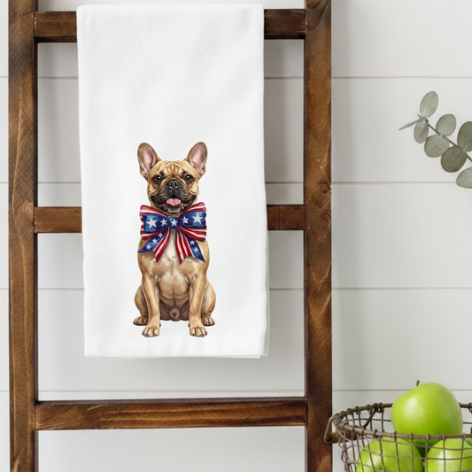 Towel with a French Bulldog wearing a USA flag bow tie on a wooden ladder against a white wall.