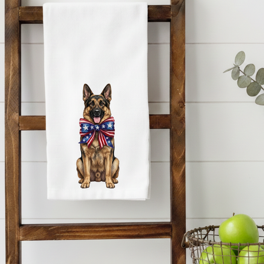 Towel with a German Shepherd dog wearing an American flag bandana hanging on a wooden ladder.
