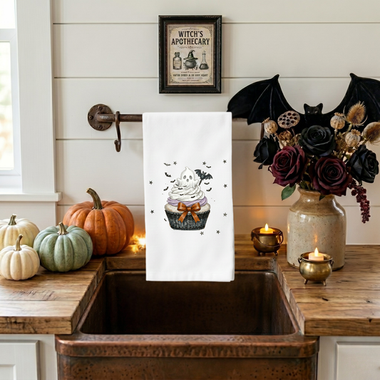 Cute Halloween kitchen towel featuring a ghost cupcake design displayed on a copper farmhouse sink