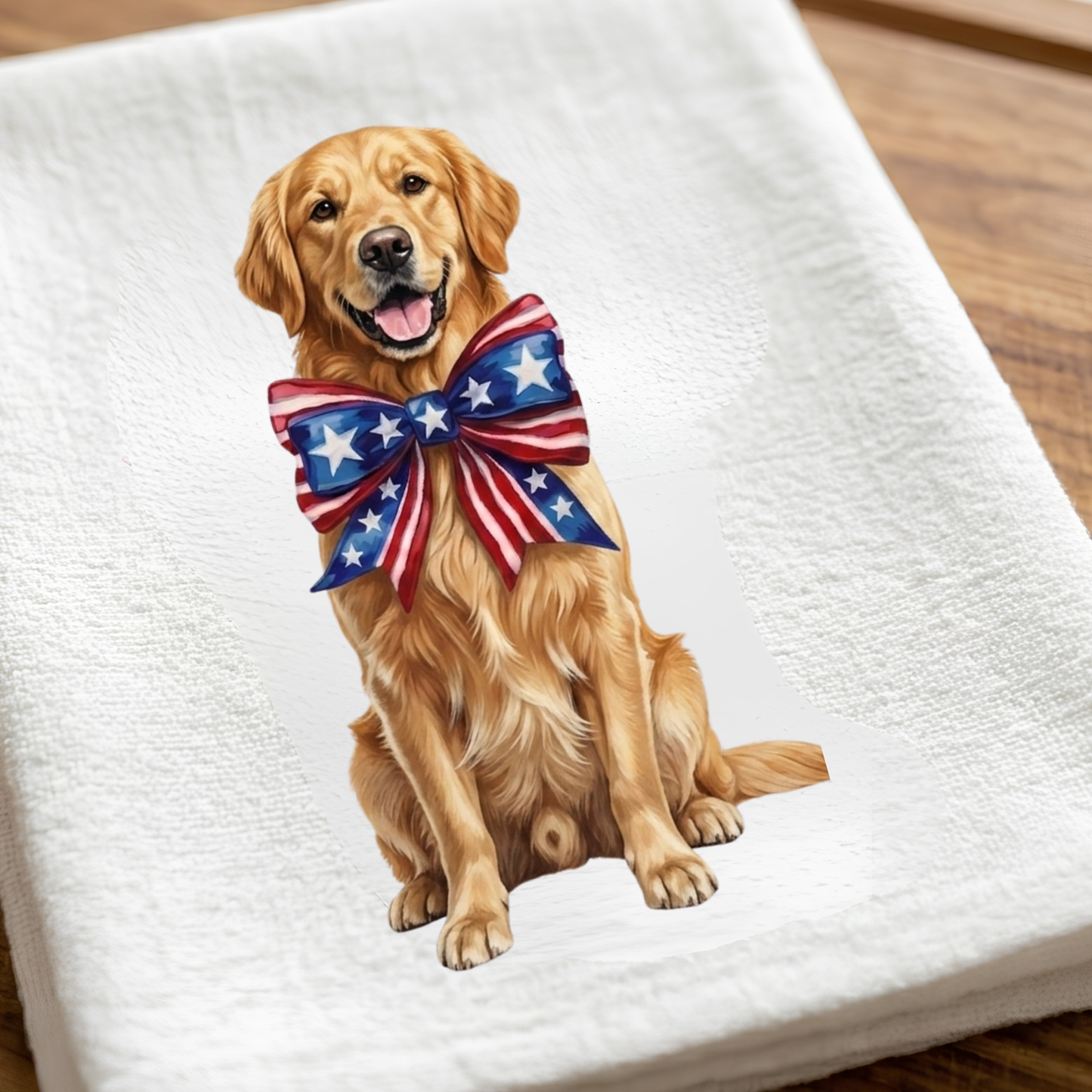 Golden retriever with a patriotic bow on a white towel