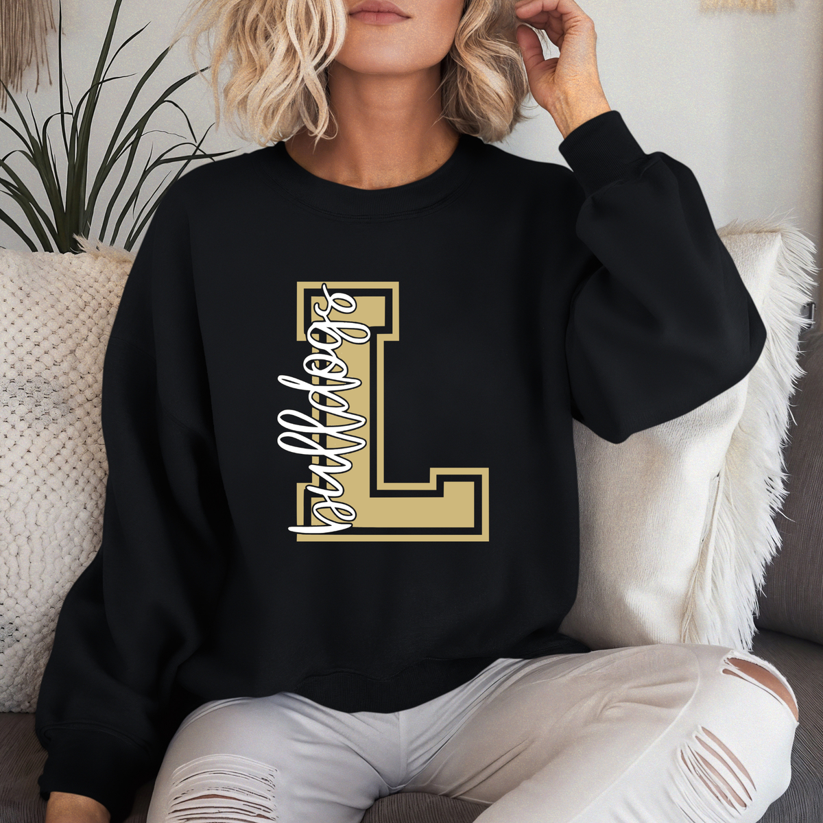 Woman wearing a Lapel Bulldogs Varsity L crewneck sweatshirt featuring varsity letter L and Bulldogs script design on black sweatshirt