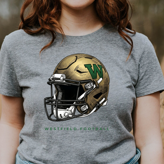 A person wearing a grey t-shirt featuring a detailed gold and green Westfield football helmet design with the text 'WESTFIELD FOOTBALL'.