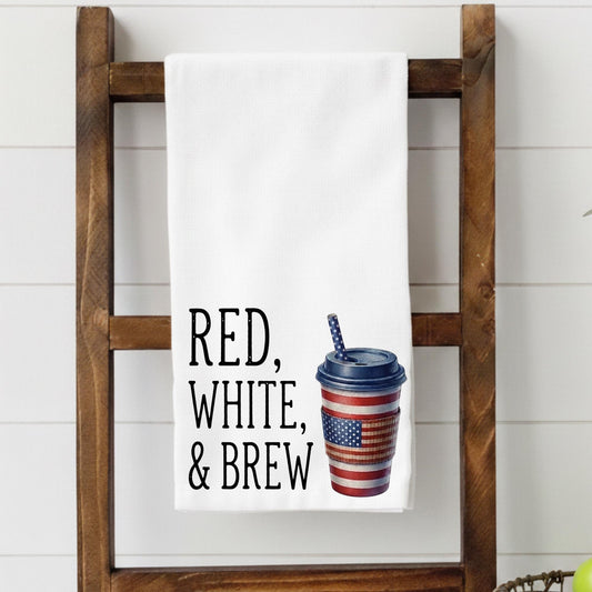 Towel with 'Red, White, & Brew' text and coffee cup graphic on a wooden ladder.