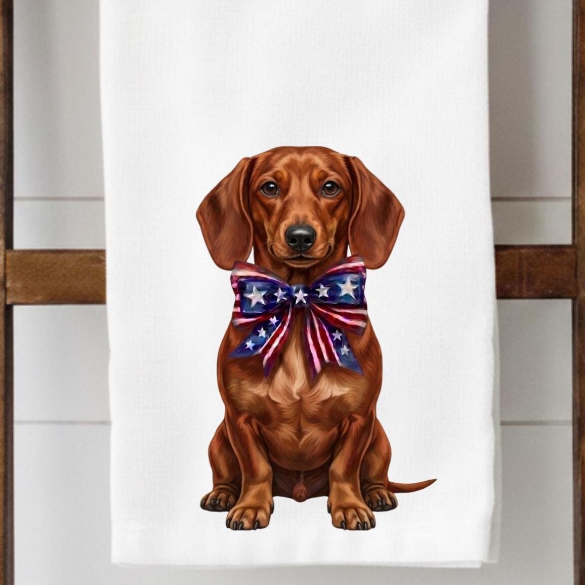 Dachshund with a patriotic bow tie on a white towel