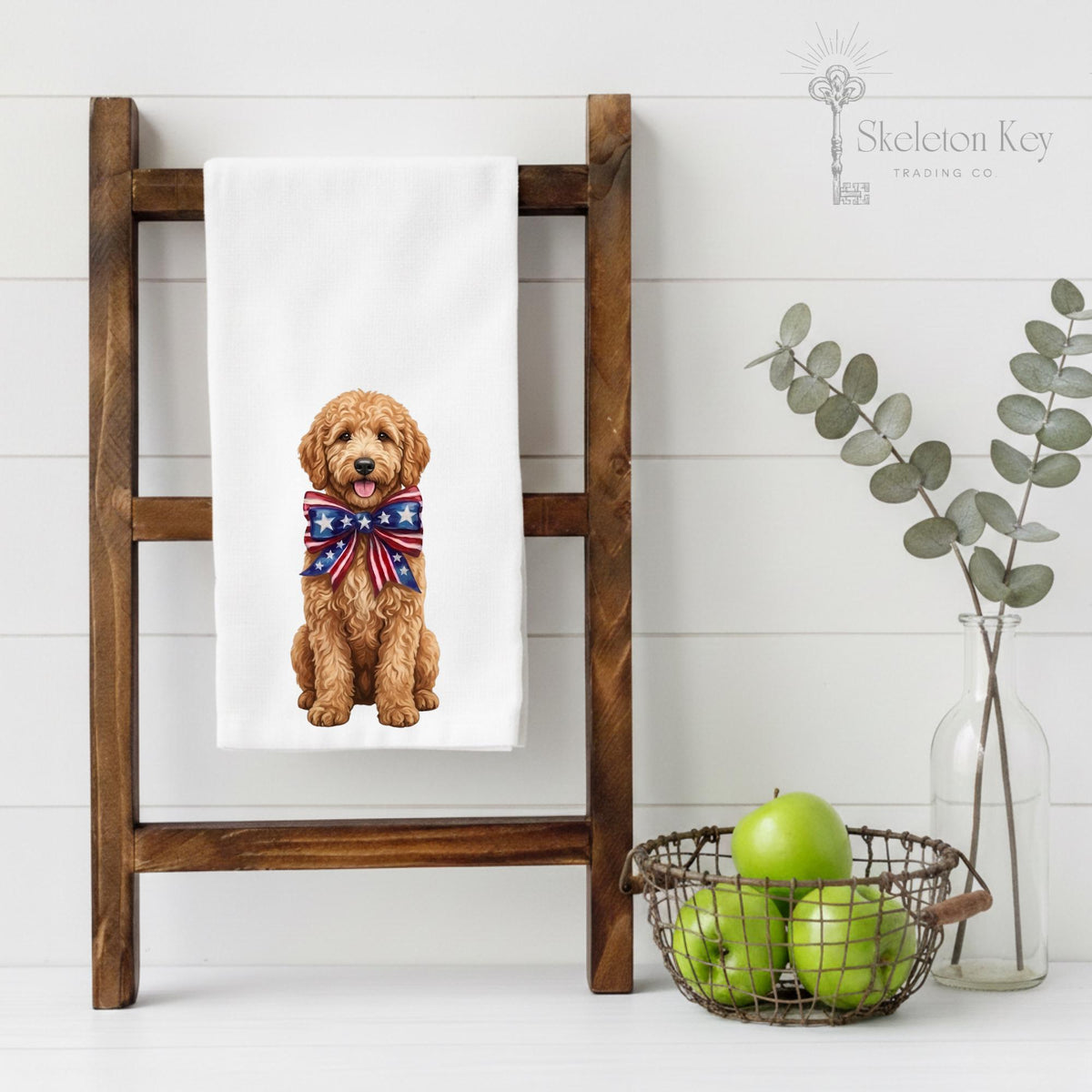 Dog towel with a dog wearing a patriotic bow tie on a wooden ladder against a white wall.