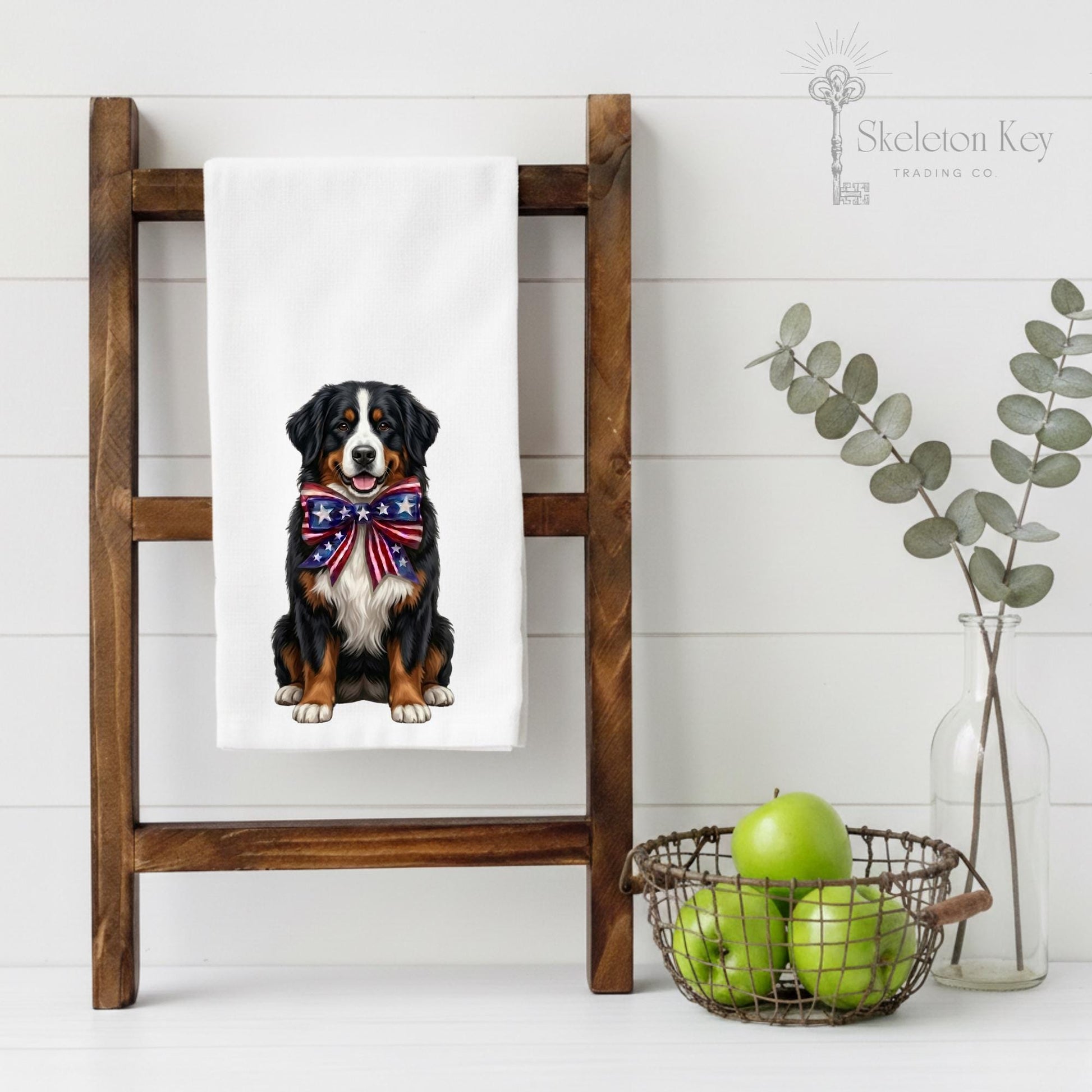 Illustration of a Bernese Mountain Dog wearing a patriotic bow on a flour sack towel on a ladder kitchen towel display.
