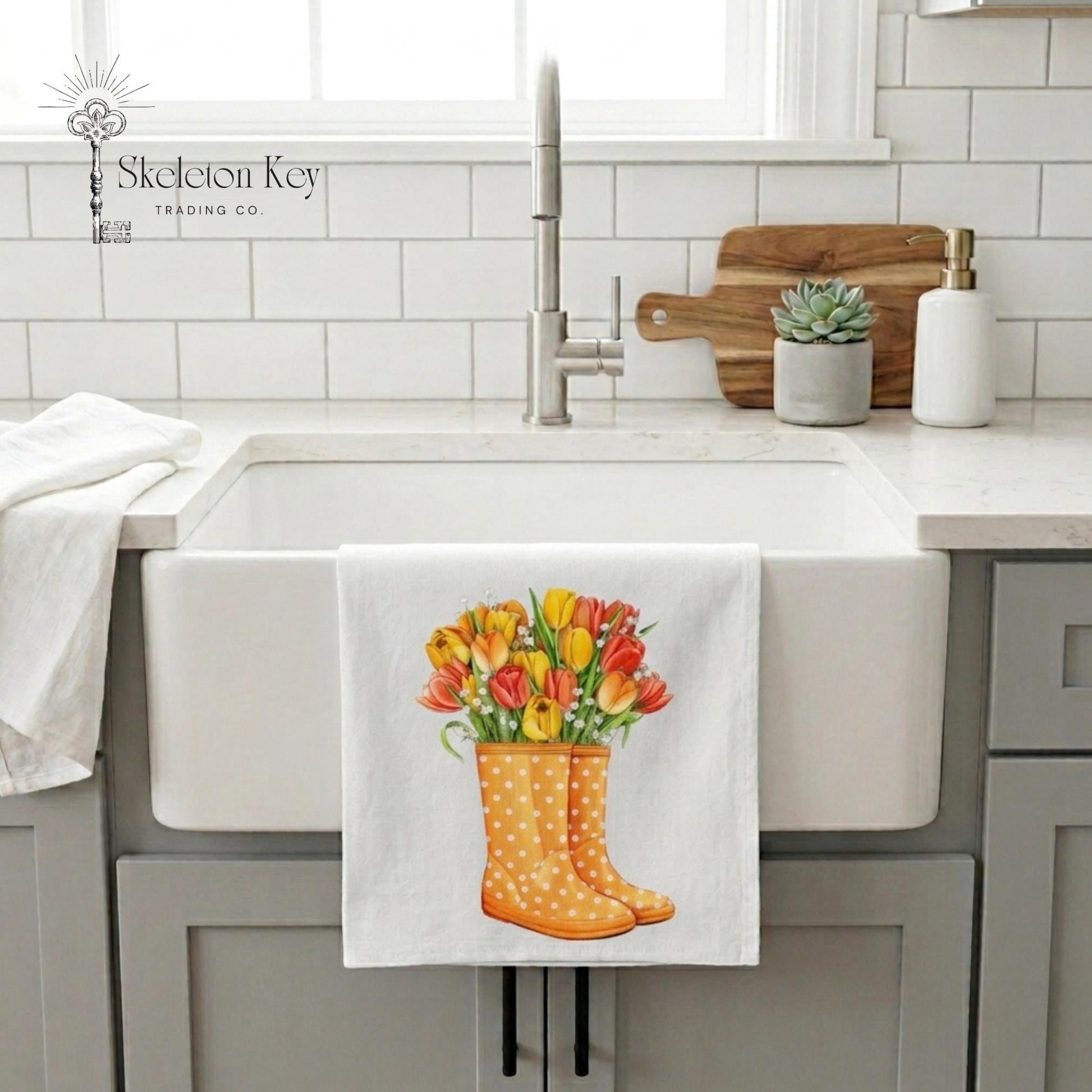 Kitchen sink with a towel featuring floral rain boots hanging on the faucet