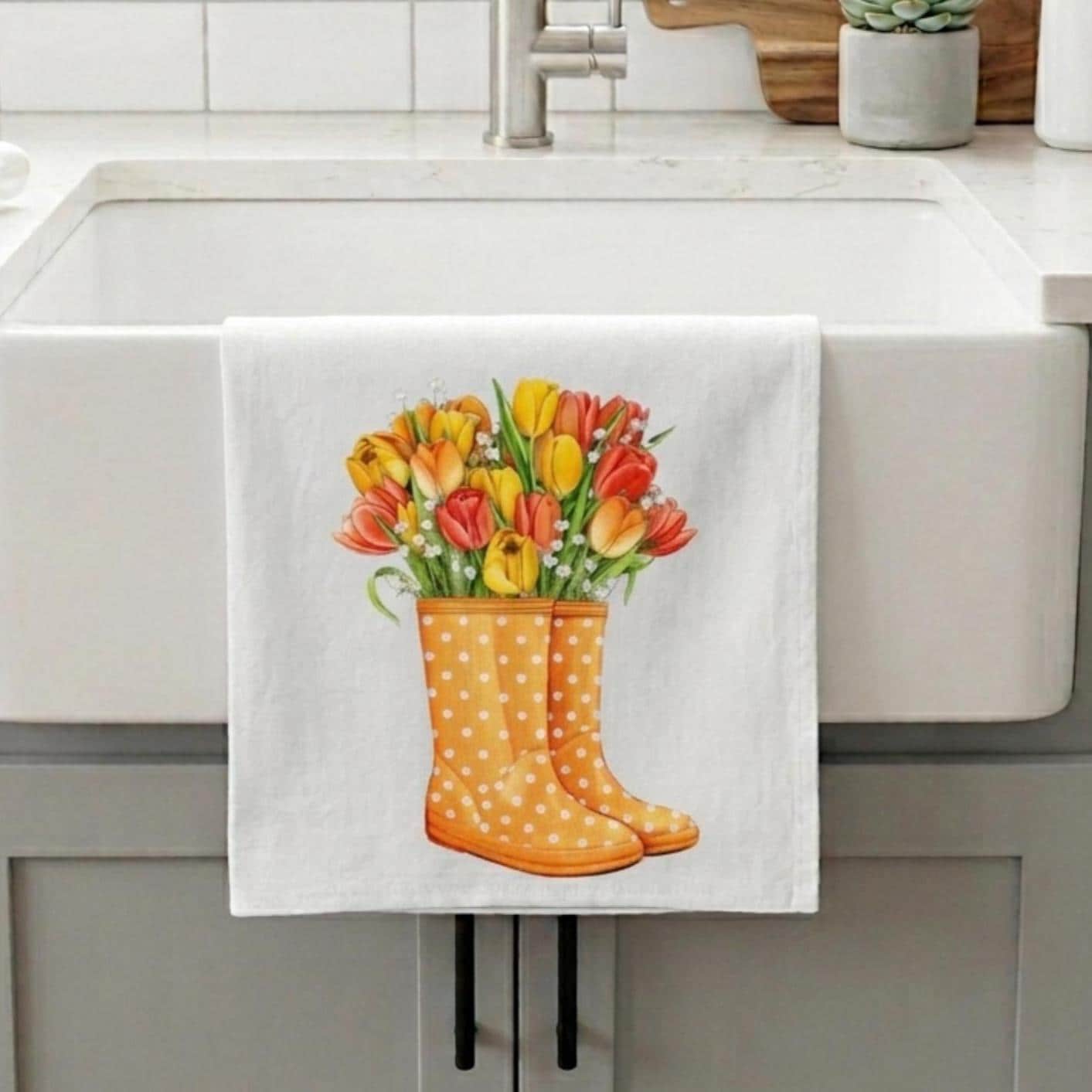 Kitchen towel with floral design hanging on a kitchen cabinet