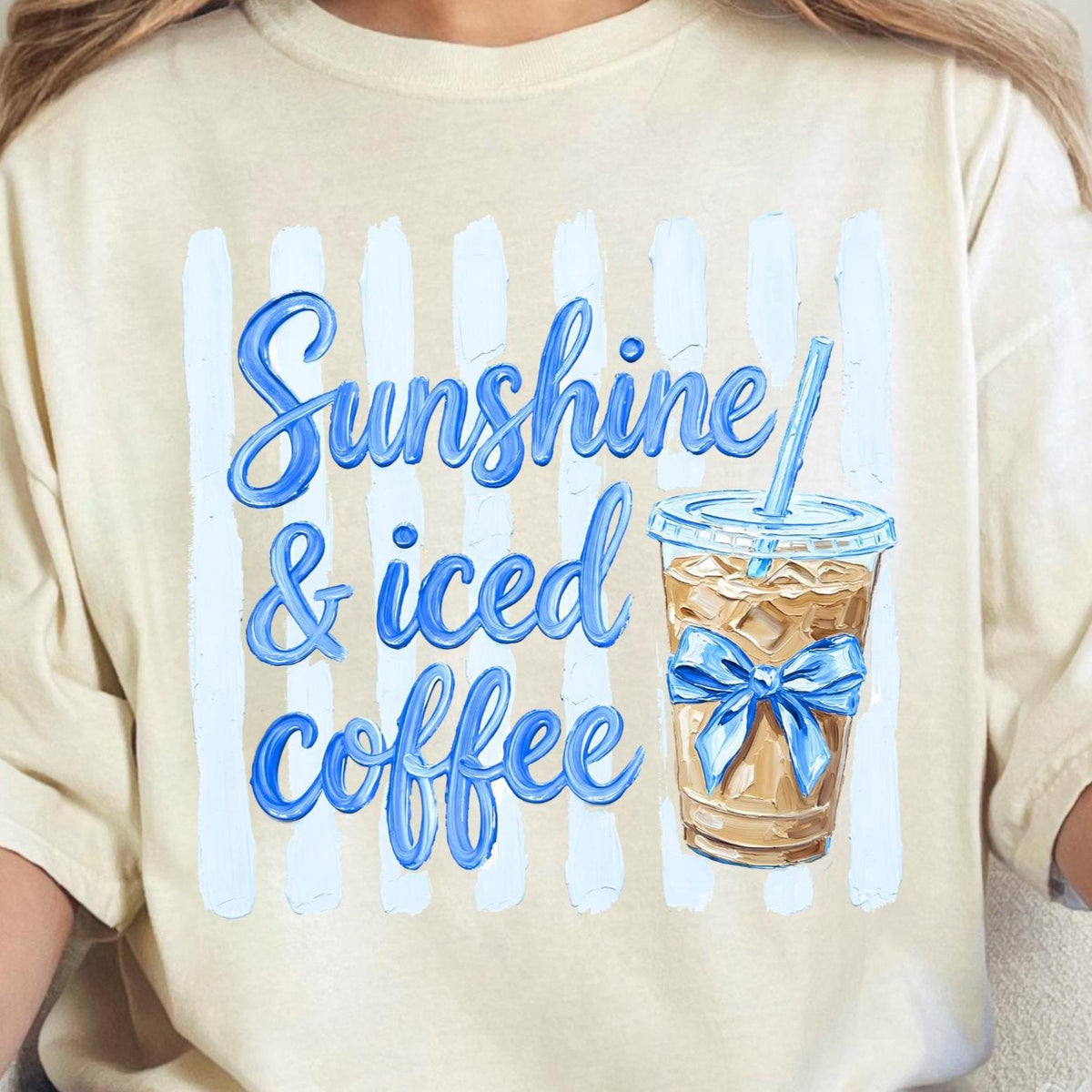 Beige t-shirt with 'Sunshine & iced coffee' design featuring a cup with a blue bow.