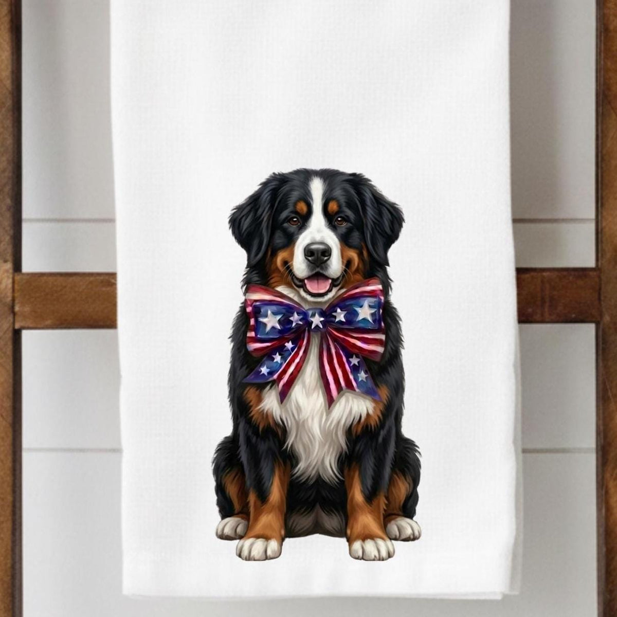 Bernese Mountain Dog with a patriotic bow tie on a white towel