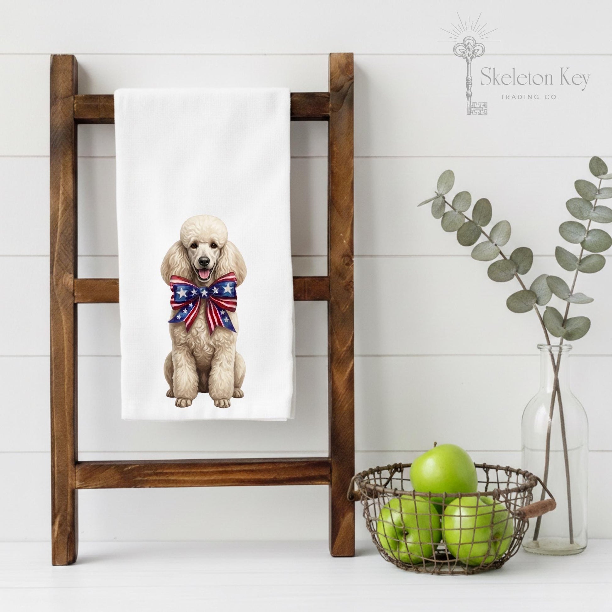 Towel with a dog wearing a patriotic bow tie on a wooden ladder against a white wall.