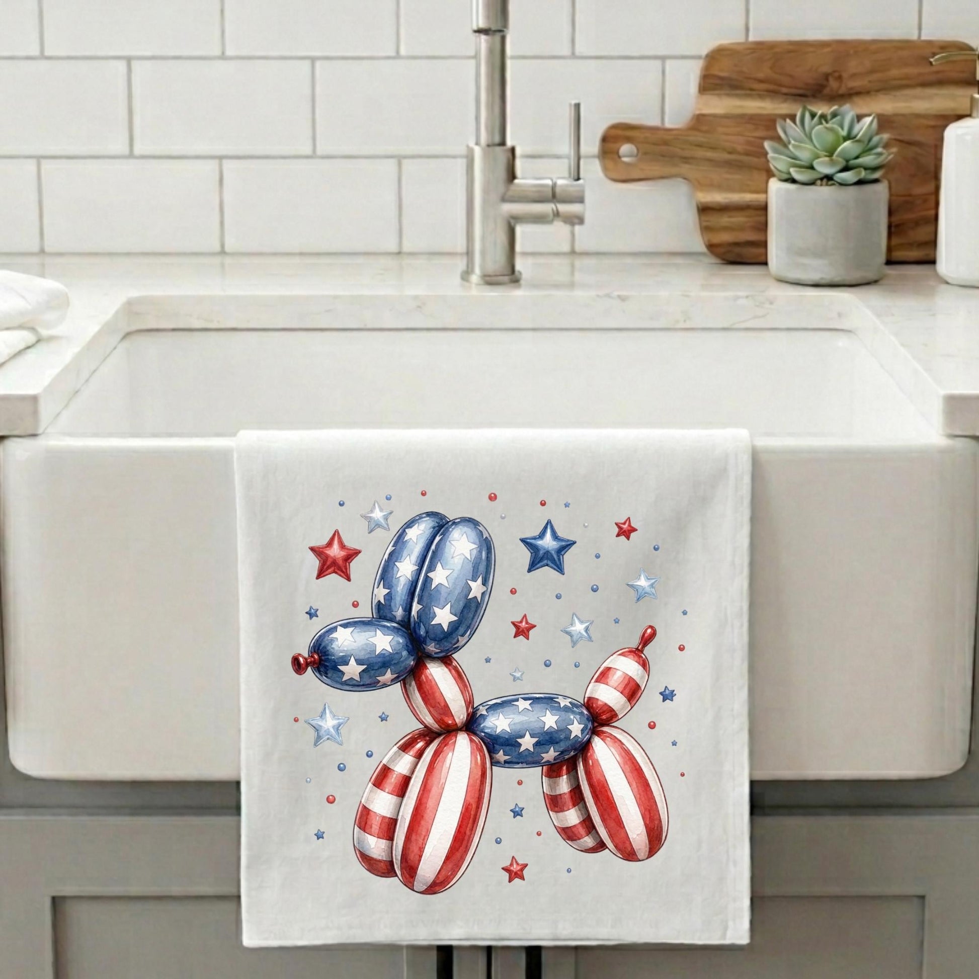 Kitchen towel with a patriotic balloon dog design hanging on a kitchen wall.