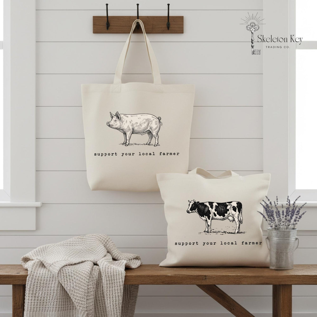 Tote bags with farm animal illustrations and 'support your local farmer' text on a wooden bench.