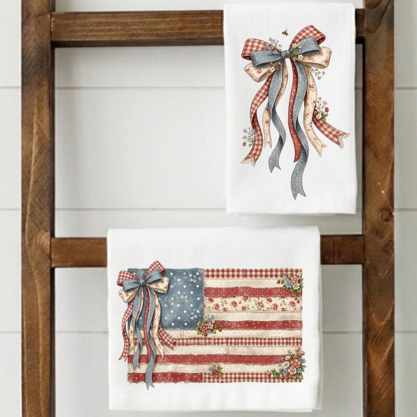 Set of two patriotic kitchen towels featuring vintage Americana flag and farmhouse bow designs displayed on wooden ladder