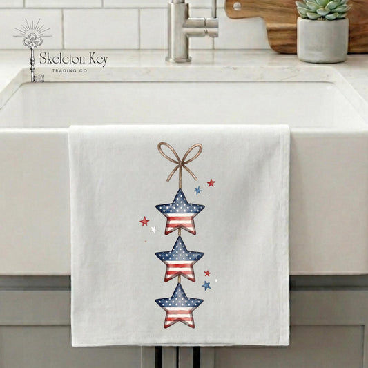 Towel with star design hanging on a kitchen sink