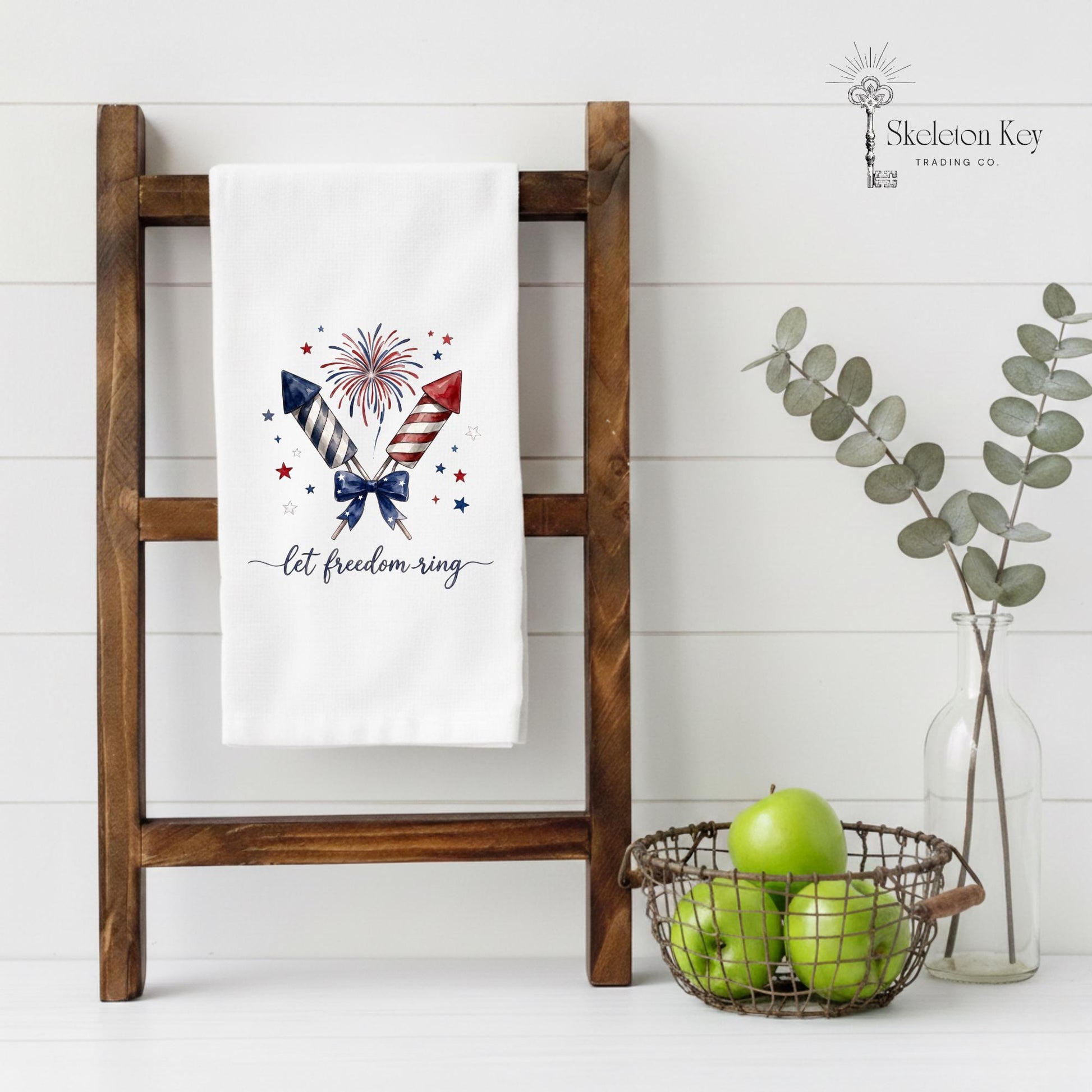 Decorative towel with patriotic design on a wooden ladder against a white wall.