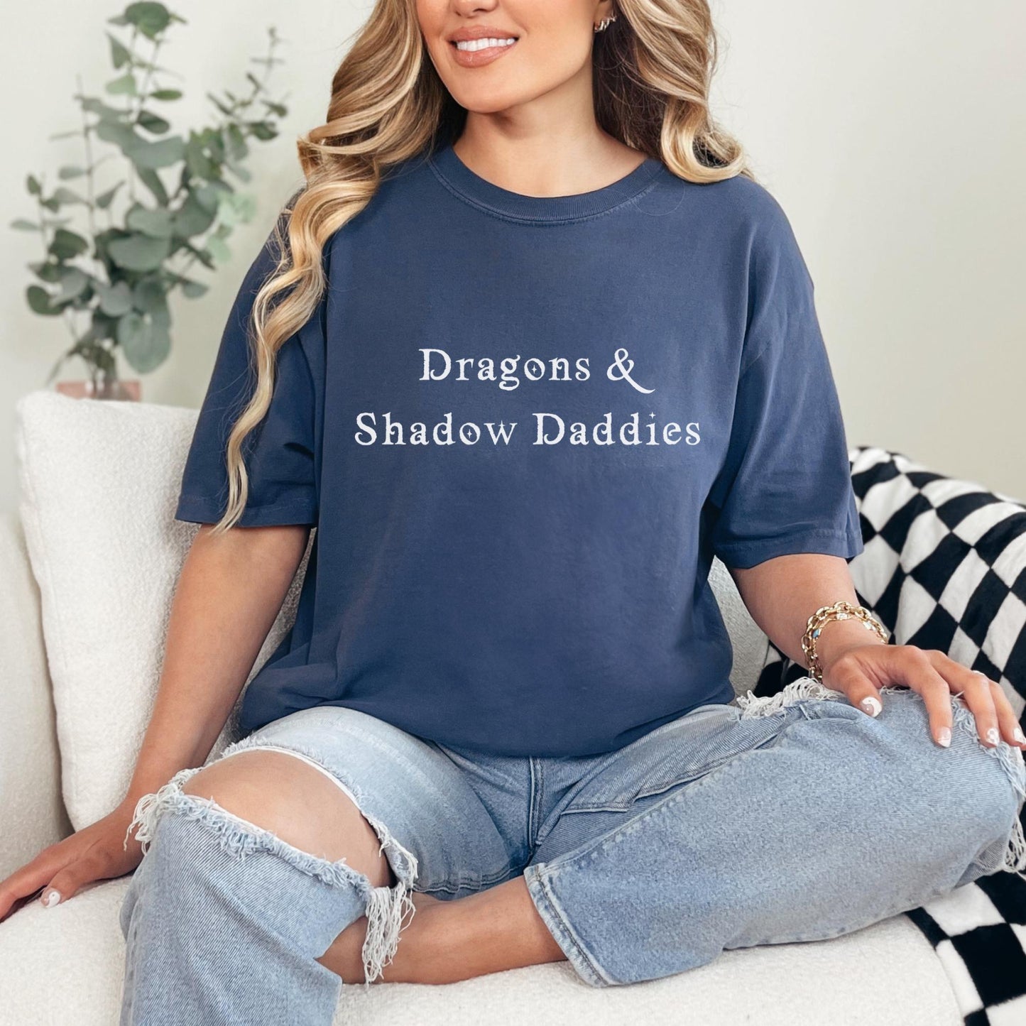 Woman wearing Dragons & Shadow Daddies shirt styled with denim jeans for a casual fantasy reader outfit