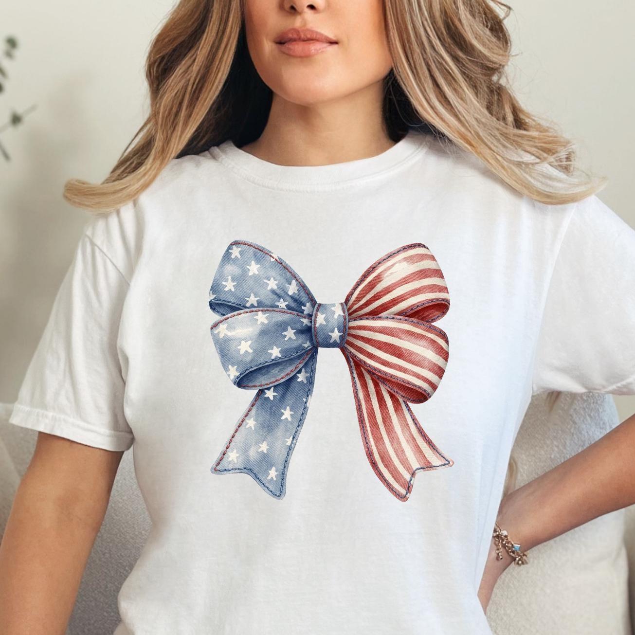 Woman wearing a white patriotic bow graphic tee with Americana coquette bow design for Fourth of July celebrations