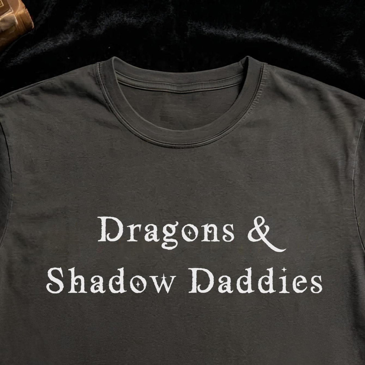 Black t-shirt with 'Dragons & Shadow Daddies' text on a dark background